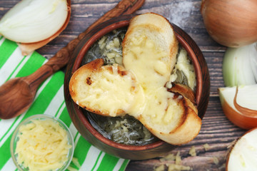 A ceramic pot with French onion soup