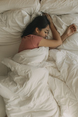 Obraz na płótnie Canvas Tired woman rest and sleep in her warm bedroom.