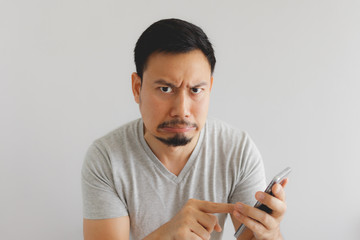 Man feels hate and disgusted with what show on the smartphone.