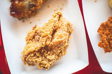 Crispy fried chicken junk food in the paper box of a franchise cafe.
