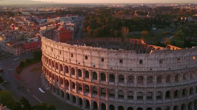 colosseum aerial view at sunrise fly orbit rome skyline italy