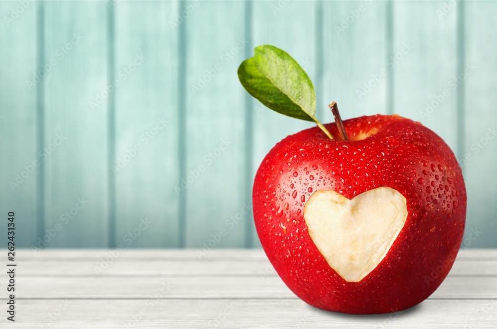 Wall mural red apple with a heart shaped