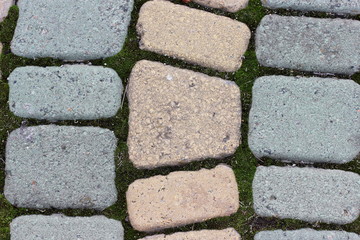 Abstract bokeh background of paved stone and lawn. garden path