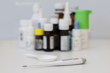 medicine bottles for children and a thermometer
