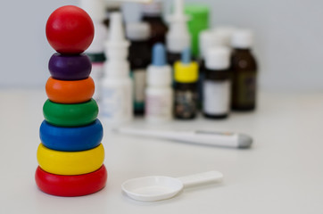 medicine bottles for children and a thermometer