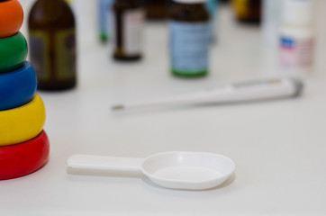 medicine bottles for children and a thermometer