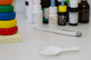 medicine bottles for children and a thermometer
