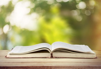 Open book on old wooden table