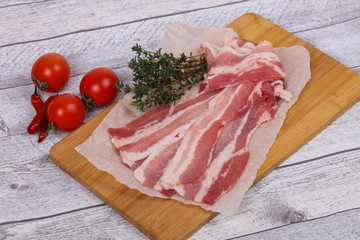 Raw bacon on the board