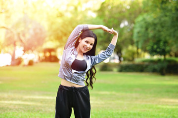 Asia Woman keep fit body exercise Stretch the muscles for health in the garden