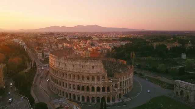 rome colosseum aerial shot drone flying orbit around at sunrise italy