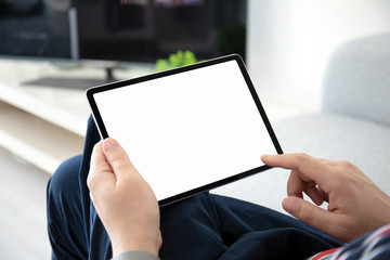 man hands holding computer tablet with isolated screen in the room