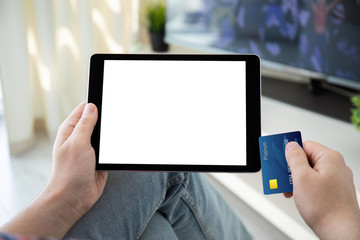 male hands holding bank card and computer tablet isolated screen