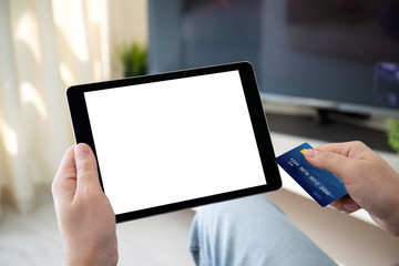 male hands holding bank card and computer tablet isolated screen