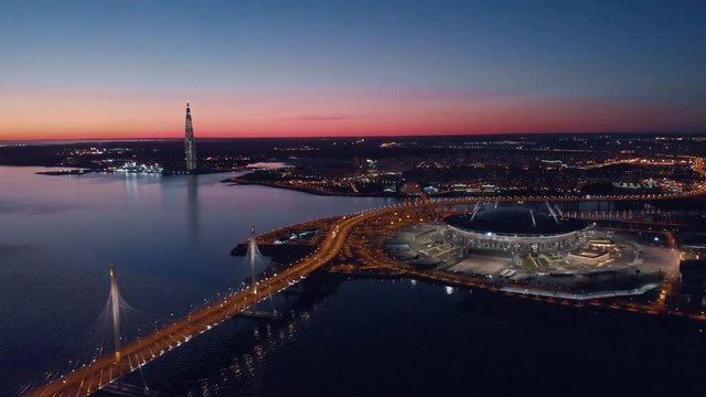 Saint-Petersburg, Russia. Aerial views to Gazprom Arena stadium as known as Zenit Arena and Krestovsky stadium illuminated Gazprom Arena in a spring evening.