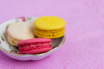 Macaroons fresh colorful close up. French dessert food background.