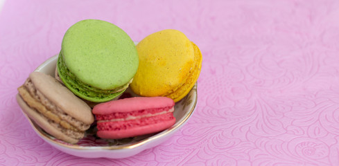 Macaroons fresh colorful close up. French dessert food background.