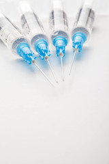 Hypodermic syringe. Syringes with blue needles. Medical Injectors.