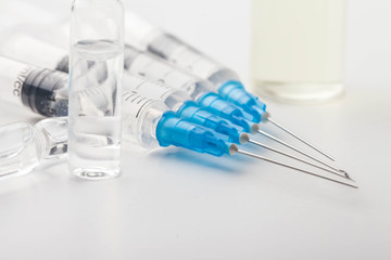 Hypodermic syringe. Syringes with blue needles. Medical Injectors.