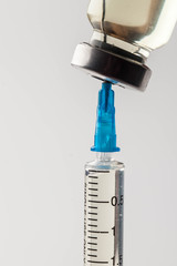 Medical syringe and vial for intravenous administration of the drug on a light background