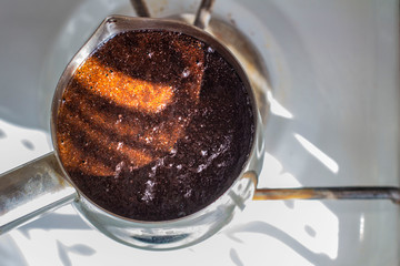 Barista preparing hot tasty drink from copper turk, boils water for coffee on small fire in cezve. Coffee turk made of organic copper, cezve to kitchen. Copper turk for real gourmet coffee at cezve