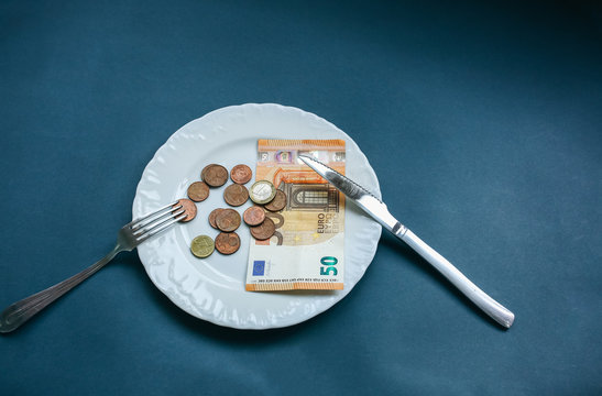 Fifty Euros Lying On The Plate With Fork And Knife. No Money Photo. Poor People Idea. Cents Coins. Small Salary And Pension Not Enough For Food. Social Problems.