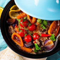 Tasty spicy beef with various vegetables cooked in tagine