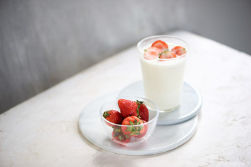 Strawberry homemade yogurt with fresh strawberries on white table