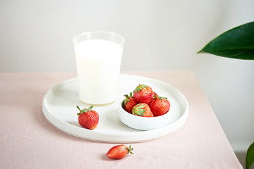 strawberry and yogurt on pink background