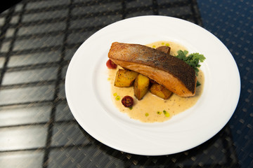 Deep Fried Salmon Seabass fish cut meat with fried potato chip, Fusion food stylish arrange on glass table, empty copy space for text logo Yummy