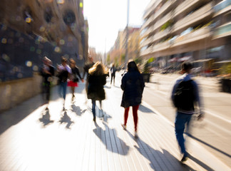 Busy city people going along the street. Intentional motion blur