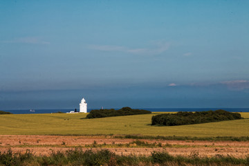 Fototapeta na wymiar landscape with lighthouse and blue sky