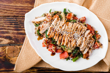 healthy salad with quinoa, vegetables and grilled chicken