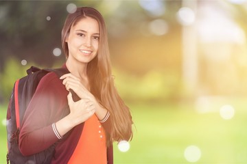 Young smilling female college student with backpack