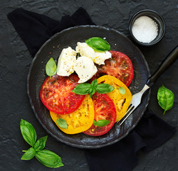 salad of yellow and red tomatoes with mozzarella. .