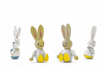 Two toy Easter bunnies sitting side by side with their father and mother turning their backs on each other in the background. Quarrel, divorce. Children suffer.