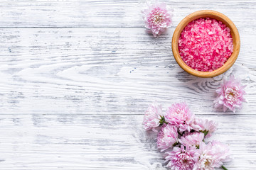 aroma therapy with pink flower fragrance and spa salt on white wooden background top view space for text