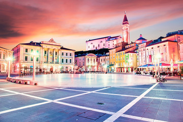 Beautiful amazing city scenery in the central square with the old clock tower in Piran, the tourist...