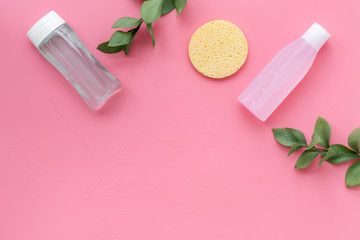 Organic cosmetics for face clearing with sponge, facial tonic and mycelial water on pink background...