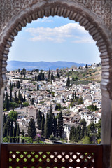 View of the Albayzin district of Granada, Spain, from an arched window in the Alhambra palace Granada, Spain