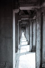 Long corridor of pillars in temple ruins, Angkor Wat in Cambodia