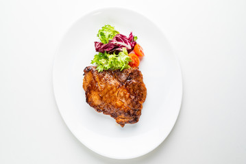 steak with salad on the white plate