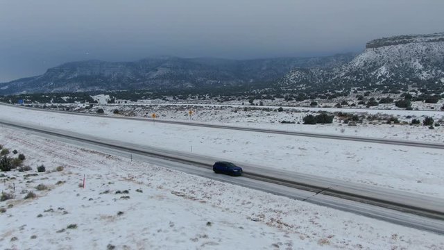 34 second drone footage of Acura RDX traveling through a snowy road at the Rocky Mountains, Colorado. 4k video with Mavic 2 Zoom. March 2019.