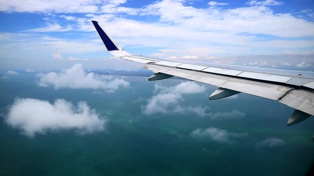 cloudy ocean areal view from commercial airplane windows