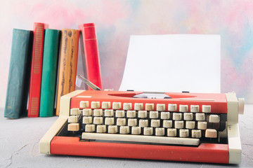 Typewriter on the table with books