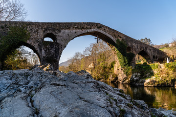 Fototapeta na wymiar Old Roman stone bridge in Cangas de Onis