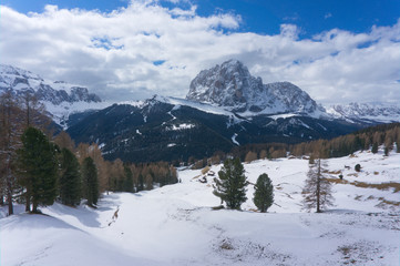 Fototapeta na wymiar Langkofel mountain near wolkenstein in winter with snow and ice, giant rock, Sasso Piato in the Dolomites Alps, Italy