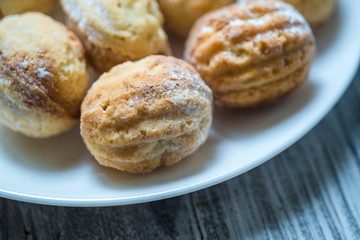 Cream cookies on the white plate, close-up 