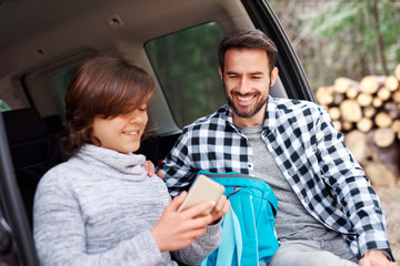 Smiling man and his son during spring road trip