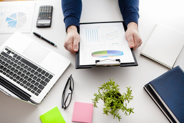 stock market chart and finger pointing on tablet in office